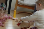 Markus helping his little sister open her Christmas gift. 
