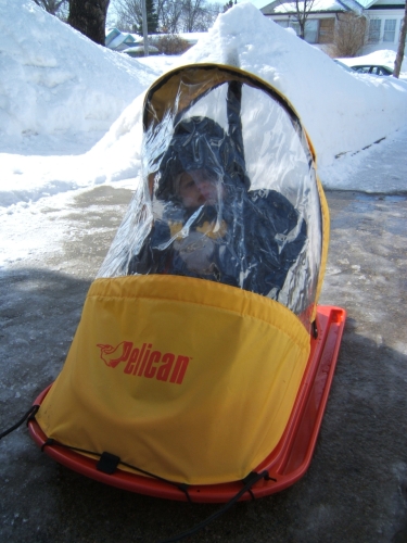 In my sled: the plastic keeps the wind out.
