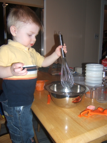 Helping to bake his birthday cake. 