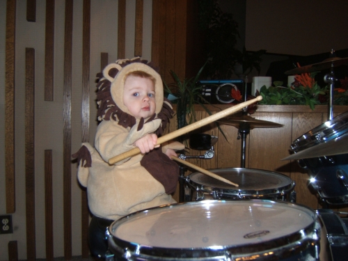 Our little lion drumming away.
